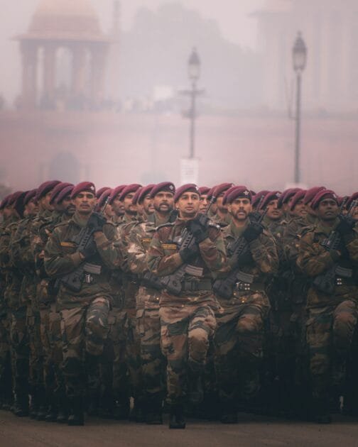 A group of soldiers in military uniforms standing together during a training or operation.