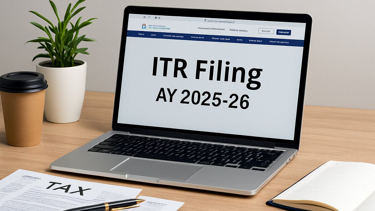 Laptop on a wooden desk showing the Income Tax e-filing portal for ITR Filing AY 2025-26, surrounded by tax papers, pen, coffee cup, and notebook