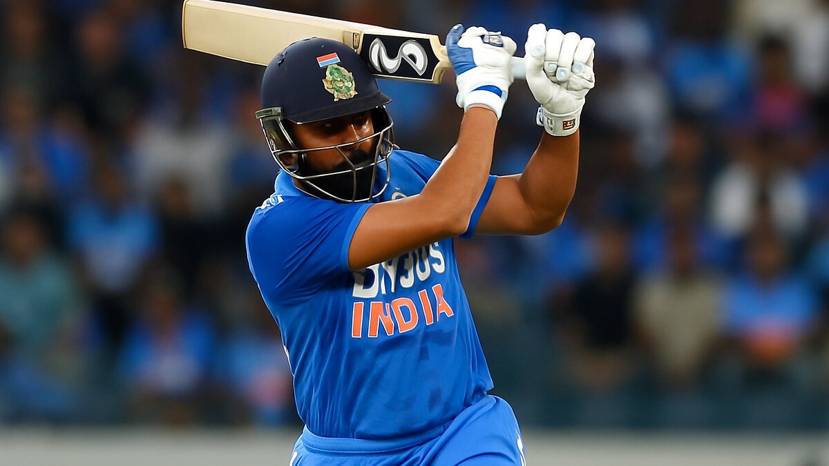 Asia Cup 2025: An Indian cricket batsman in blue jersey captured mid-swing during a T20 match, showing intense focus and action on the field.