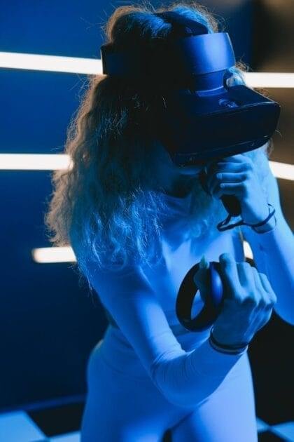 Metaverse Revolution - woman using virtual reality simulator